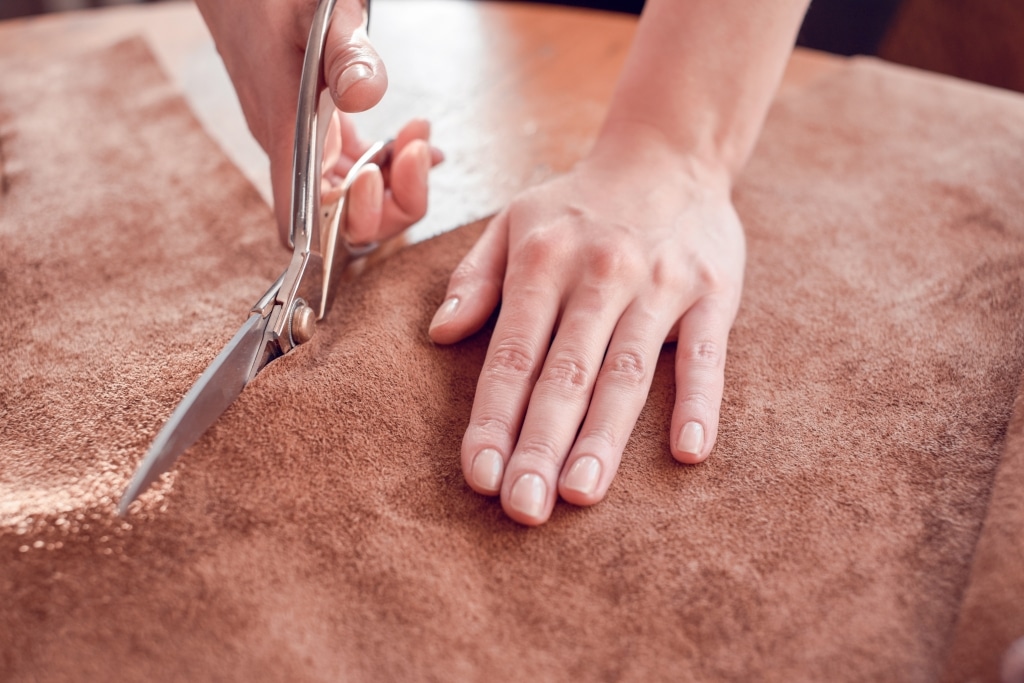 Cutting leather with scissors